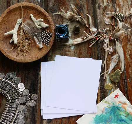 Rustic wooden background with boho chic style decorations: dreamctcher, cup of cappuccino, notebook and paper stars. Copy space for text. Natural, rustic, ethnic or hipster vintage mock up. Top view.の写真素材