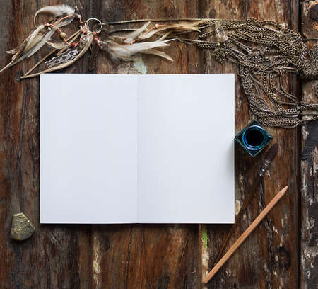 Rustic wooden background with boho chic style decorations: dreamctcher, cup of cappuccino, notebook and paper stars. Copy space for text. Natural, rustic, ethnic or hipster vintage mock up. Top view.の写真素材