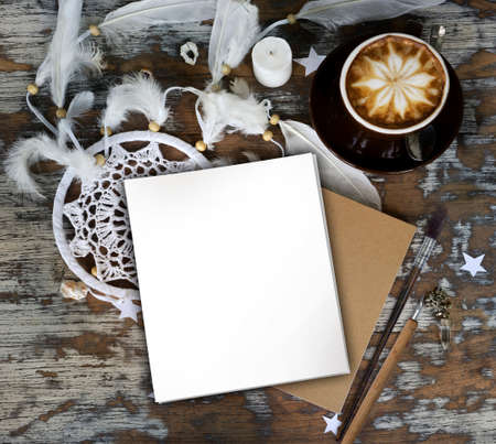 Boho cracky background for mockup with cup of cappuccino. Desk for artist, painter. Copy space for text. Natural, rustic, ethnic or hipster vintage mock up. Top view. Shabby chic style workplaceの写真素材