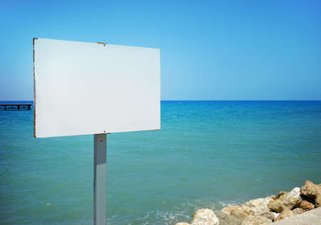 Empty sign board with copy space on a beautiful tropical beach.の写真素材