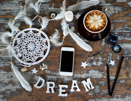 Boho cracky background for mockup with cup of cappuccino. Desk for artist, painter. Copy space for text. Natural, rustic, ethnic or hipster vintage mock up. Top view. Shabby chic style workplaceの写真素材