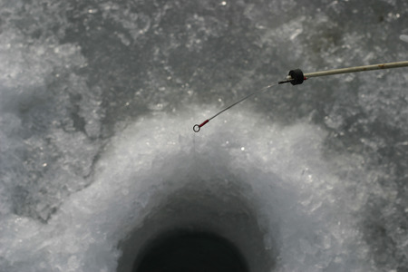 Rod. hole in the ice. close-up
