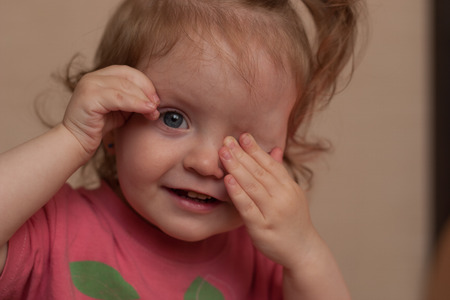 portrait of a little girl,closes one eye handの写真素材