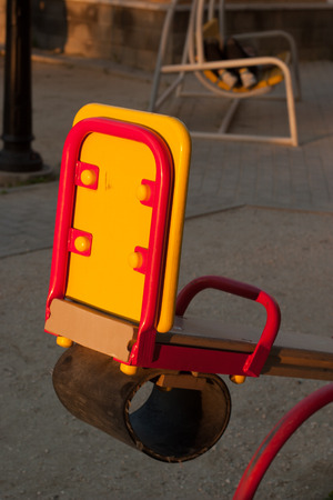 Child seats seesow red and yellow with a round rubber guardの写真素材