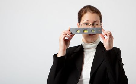 business woman looking through pocket level with one eye openの写真素材