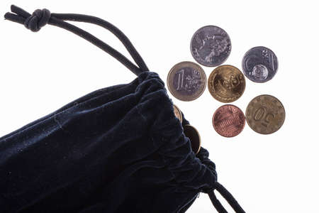 Money bag with  coins on a white backgroundの写真素材