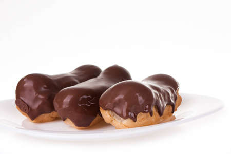 Eclairs on white plateの写真素材