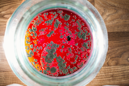 Mold on red juice in a jar.の写真素材