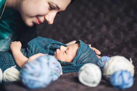 Newborn baby looks at her mother. Beautiful concept of motherhood.の写真素材
