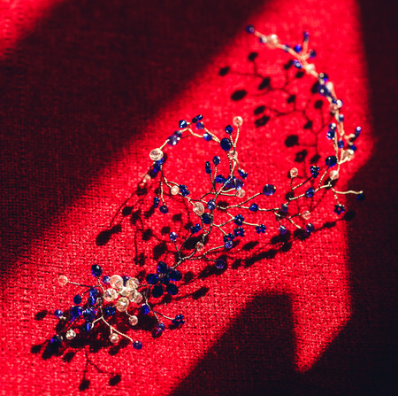 beautiful handmade hair decoration in form of twigs on red backgroundの写真素材