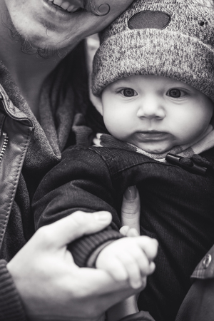 Young family hugging. Faces of dad and son close-up.の写真素材