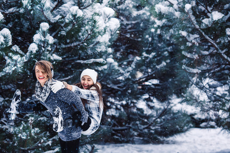 Mother and daughter have fun playing in the winter forestの写真素材