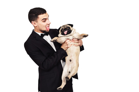 dog with a long tongue. funny pug and his master make funny muzzle. isolated on whiteの写真素材