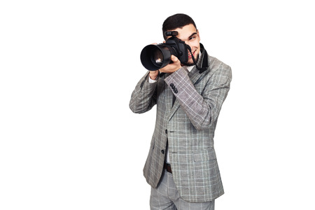 photographer at work. stylish young bearded guy takes pictures on digital camera. isolated on white