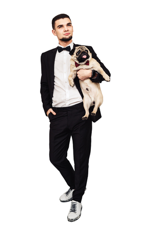 dog with a long tongue. funny pug and his master make funny muzzle. isolated on whiteの写真素材