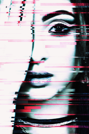 Photo with glitch effect. Young beautiful oriental girl closes the right eye with her hand.の写真素材