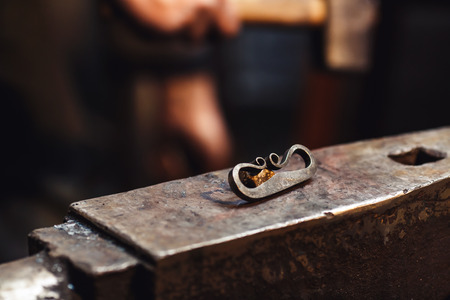 closeup of a blacksmith anvil with a firesteel and flintの写真素材