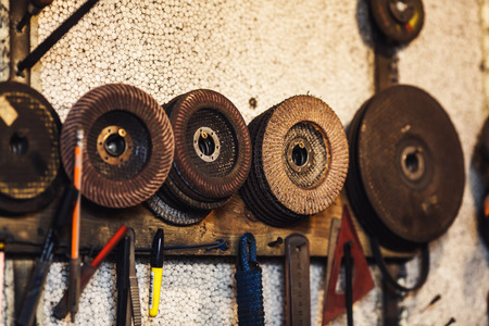 abrasive grinding wheels hang on the wall in the workshopの写真素材