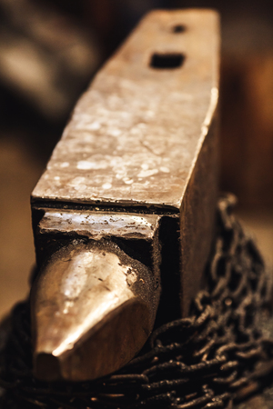 Close-up a blacksmith anvil with wound chainの写真素材