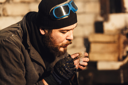 bearded blacksmith fanning fireの写真素材
