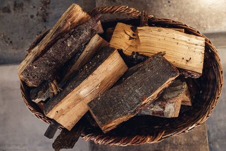 logs in basket. Heated houses with wood and coalの写真素材