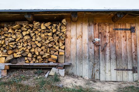 firewood stacked near the entrance of the barnの写真素材