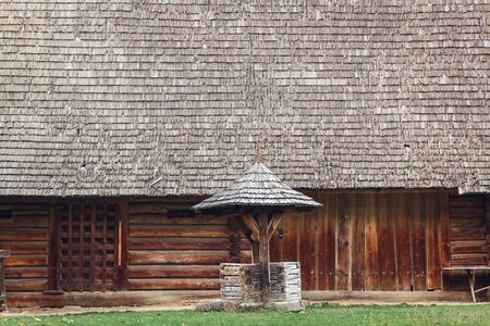 ancient wooden well of an old log houseの写真素材