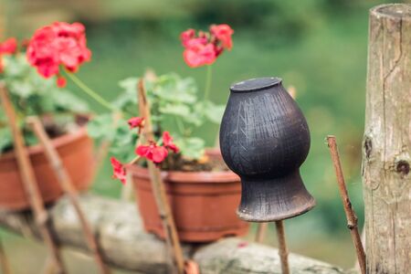black clay pot on a wicker fenceの写真素材