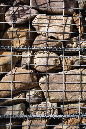 Gabions. Close-up of a steel mesh filled with large stones