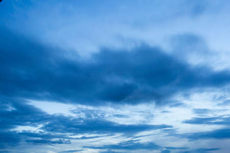 Dramatic clouds in the blue sky at sunset