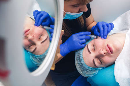 real mesotherapy procedure in the face of girl. Skin injections for rejuvenation.