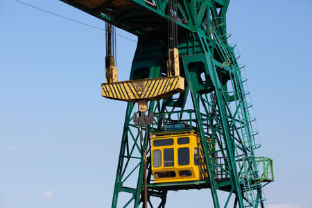 close-up of a gantry crane cabin and a hook with slings