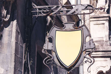 Antique medieval vintage forged retro iron sign on wall of building for your advertising, mock up.の写真素材