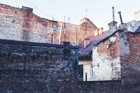 Old worn-out brick house. Brick wall is crumbling. Concept of povertyの写真素材