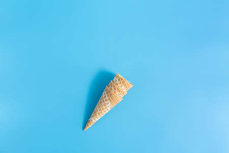Three sweet crunchy empty ice cream wafer cups on a blue backgroundの写真素材