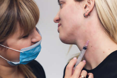 Rejuvenation of female neck skin with mesotherapy injections in a cosmetic clinic. neck skin...