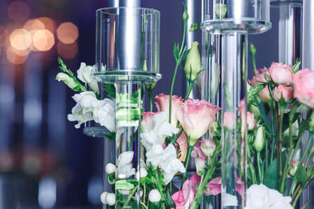 close-up of flowers and glass candlesticks. Banquet decor.