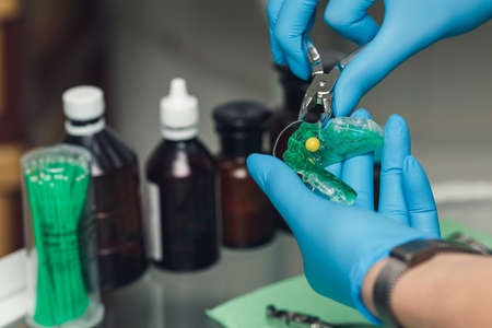 orthodontist prepares childrens braces for teeth.の写真素材