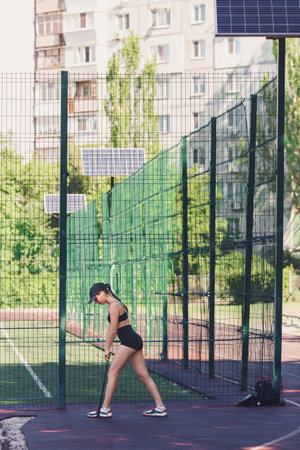 the girl does a warm-up using a rubber expander. leg muscle trainingの写真素材