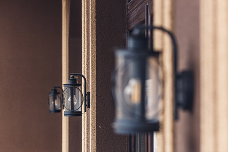 two street lamps with LED light bulb on the wall of the houseの写真素材