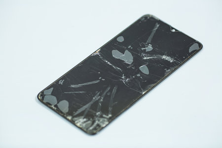 broken smartphone screen on a gray background. shallow depth of fieldの写真素材