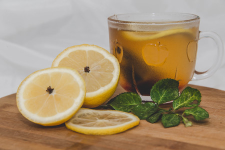 tea with lemon and sprig of rose