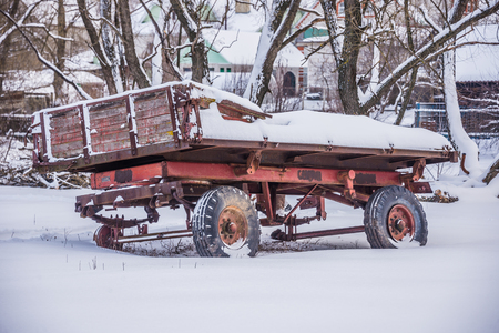 old tractor truck on wheels in the winterの写真素材