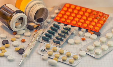 medicines are scattered on a sheet of paper, tablets in packages, means for stress, for weight loss...