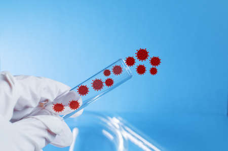 Medicine. A gloved hand holds a test tube containing the virus. Elements of a bitmap drawing. The concept of an artificially created virus. Close-up.の写真素材