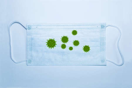 Medical mask on a white background with viruses on it. The concept of the danger of infection. A pandemic. Elements of a bitmap drawing. Close-up.の写真素材