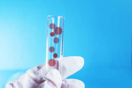 Medicine. A gloved hand holds a test tube containing the virus. Elements of a bitmap drawing. The...