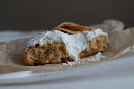 Christmas cake sprinkled with powdered sugar on the Christmas table. Christmas and New Year. Close-up.の写真素材
