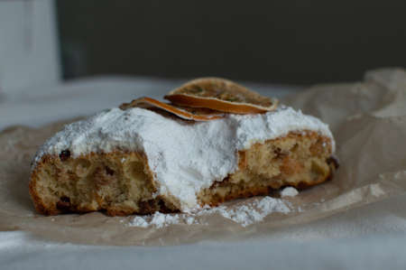 Christmas cake sprinkled with powdered sugar on the Christmas table. Christmas and New Year. Close-up.の写真素材