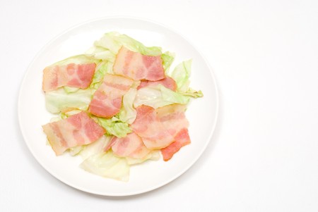 Fried food with slice bacon and cabbageの写真素材